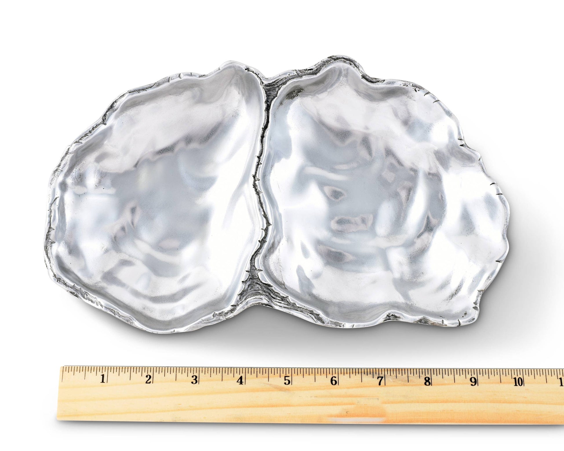 Arthur Court's sand-cast aluminum alloy is the perfect material for this Oyster shaped Catch-All Tray. The shiny luster of the tray mimics the inside of a real oyster to reflect the pretty objects you display on the tray or enhance the little treat tidbit As unique as the shell fish that inspired it's design, our Oyster Catch-All Tray is hand-crafted in Arthur Court's signature aluminum alloy. The design of an open oyster shell has plenty of room to hold glasses, keys or jewelry wherever you decide to displ