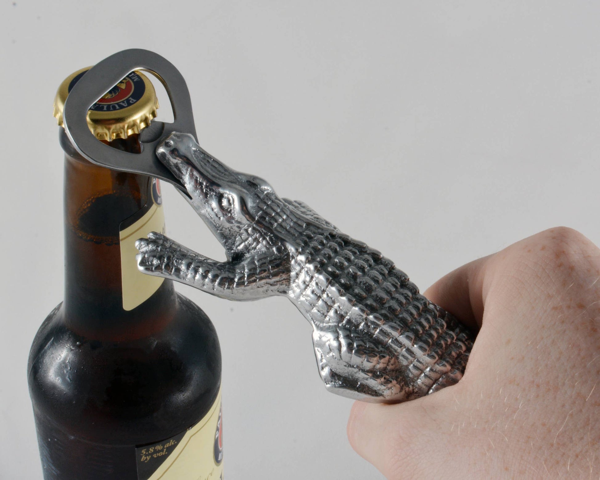 Rip the cap off any beer with this best-selling Alligator Bottle Opener from Arthur Court. Wonderfully detailed in Arthur Court's signature aluminum, this scaly alligator bites down, holding the stainless steel bottle opener with its powerful jaws. The remarkable definition in the creature's hide gives this statuette like opener a rough, naturally appealing texture. Size: L: 7.0" / W: 2.0" Care: Dust with damp cloth. Will not tarnish.