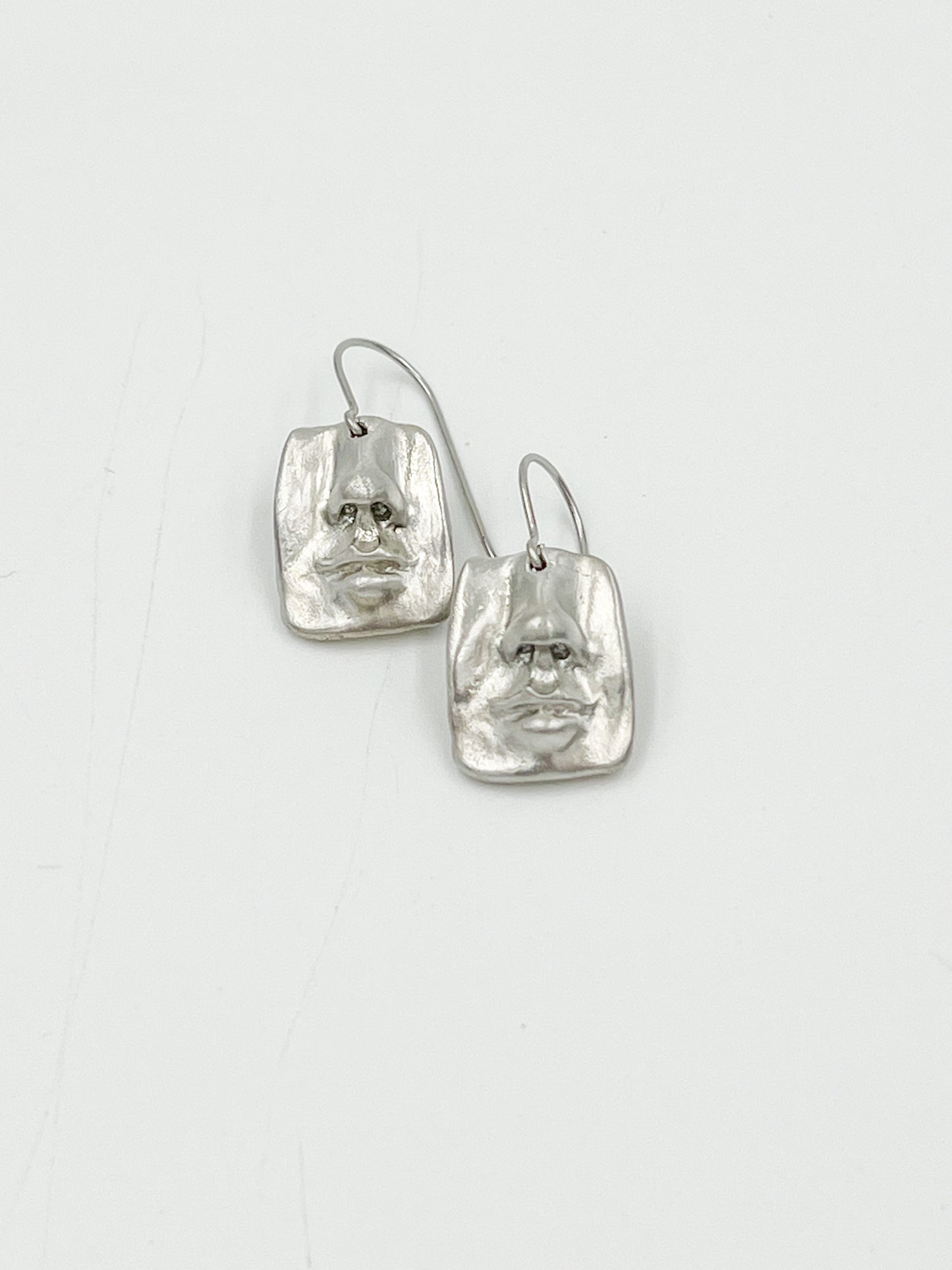 Check out these quirky Face Earrings - they have a matte finish and are made with surgical steel, so they're 100% lead and nickel free. Measuring at 3/4", they're the perfect addition to any outfit.