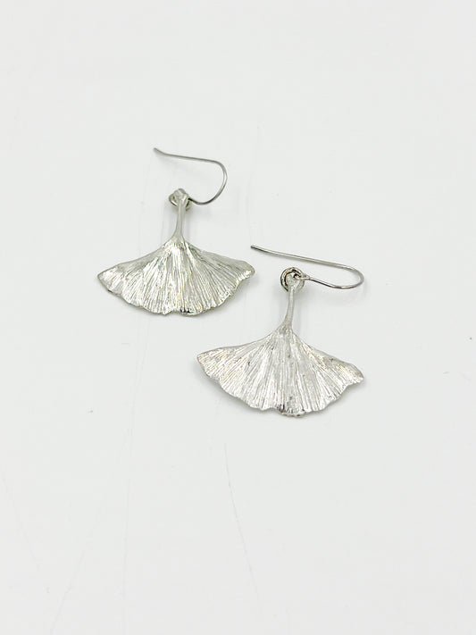 Add some natural charm to your wardrobe with our Ginkgo Wire Earrings! These earrings are crafted from highly polished pewter wire and feature the unique shape of the ginkgo leaf. Made with surgical steel, these earrings measure 1.25 inches for a comfortable fit. Get ready to leave a lasting impression with these one-of-a-kind earrings!