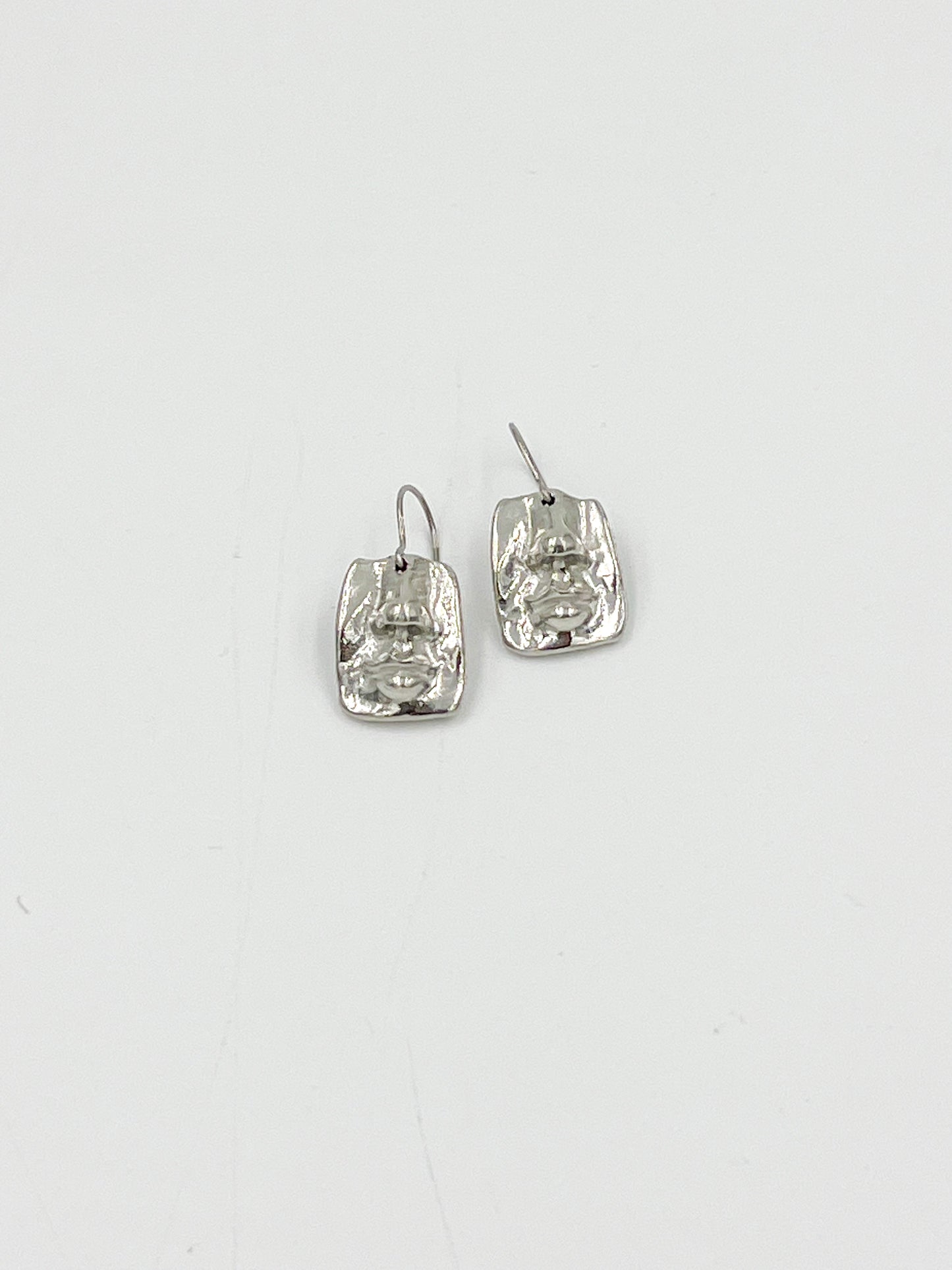 Looking for a funky and lighthearted addition to your jewelry collection? Look no further than our Face Earrings! Made with surgical steel and lead and nickel free pewter findings, these earrings are sure to be both safe and stylish. With a highly polished finish and measuring at 3/4 inches, these are perfect for adding a touch of fun and whimsy to any outfit.