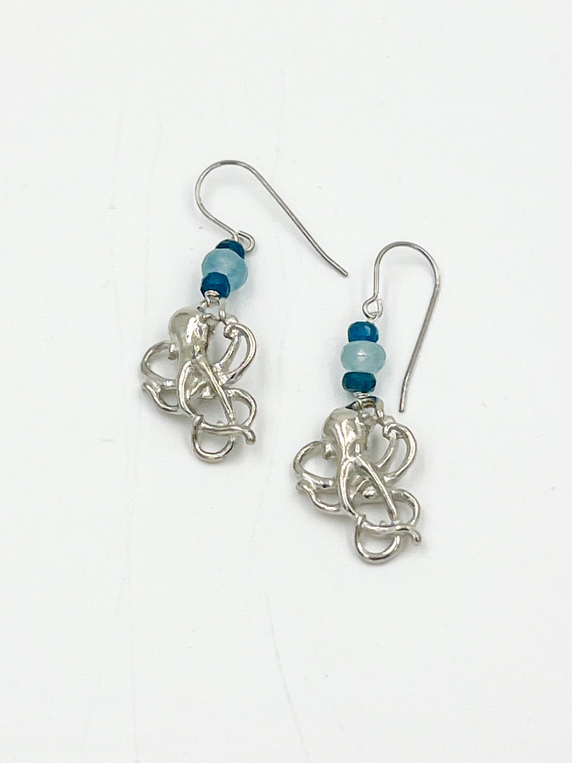 Get ready to feel like an underwater adventurer with these Angelite Octopus Earrings! Made with surgical wire and fine pewter, these earrings feature charming octopus charms and beautiful Angelite stones. This soft stone is known for its glacier blue or lilac blue color, with a white center and snow-white flecks, and sometimes even hints of brown or rusty tones. Talk about a unique addition to your jewelry collection!