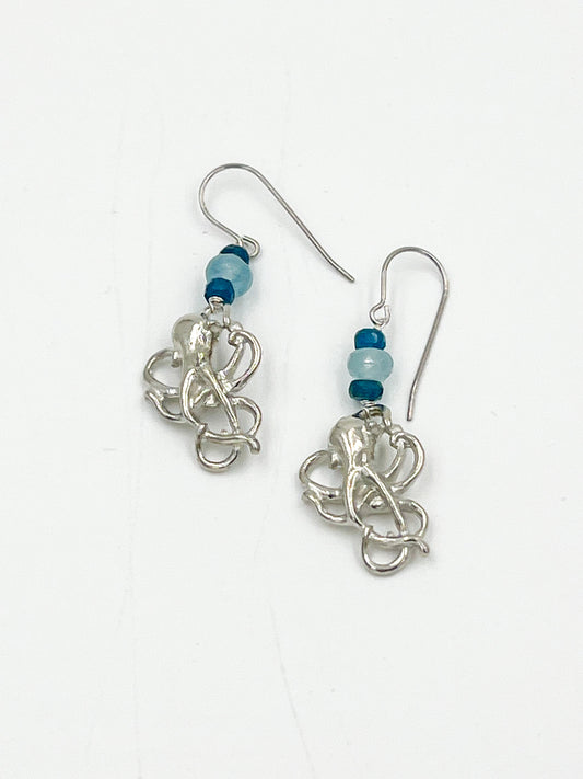 Get ready to feel like an underwater adventurer with these Angelite Octopus Earrings! Made with surgical wire and fine pewter, these earrings feature charming octopus charms and beautiful Angelite stones. This soft stone is known for its glacier blue or lilac blue color, with a white center and snow-white flecks, and sometimes even hints of brown or rusty tones. Talk about a unique addition to your jewelry collection!