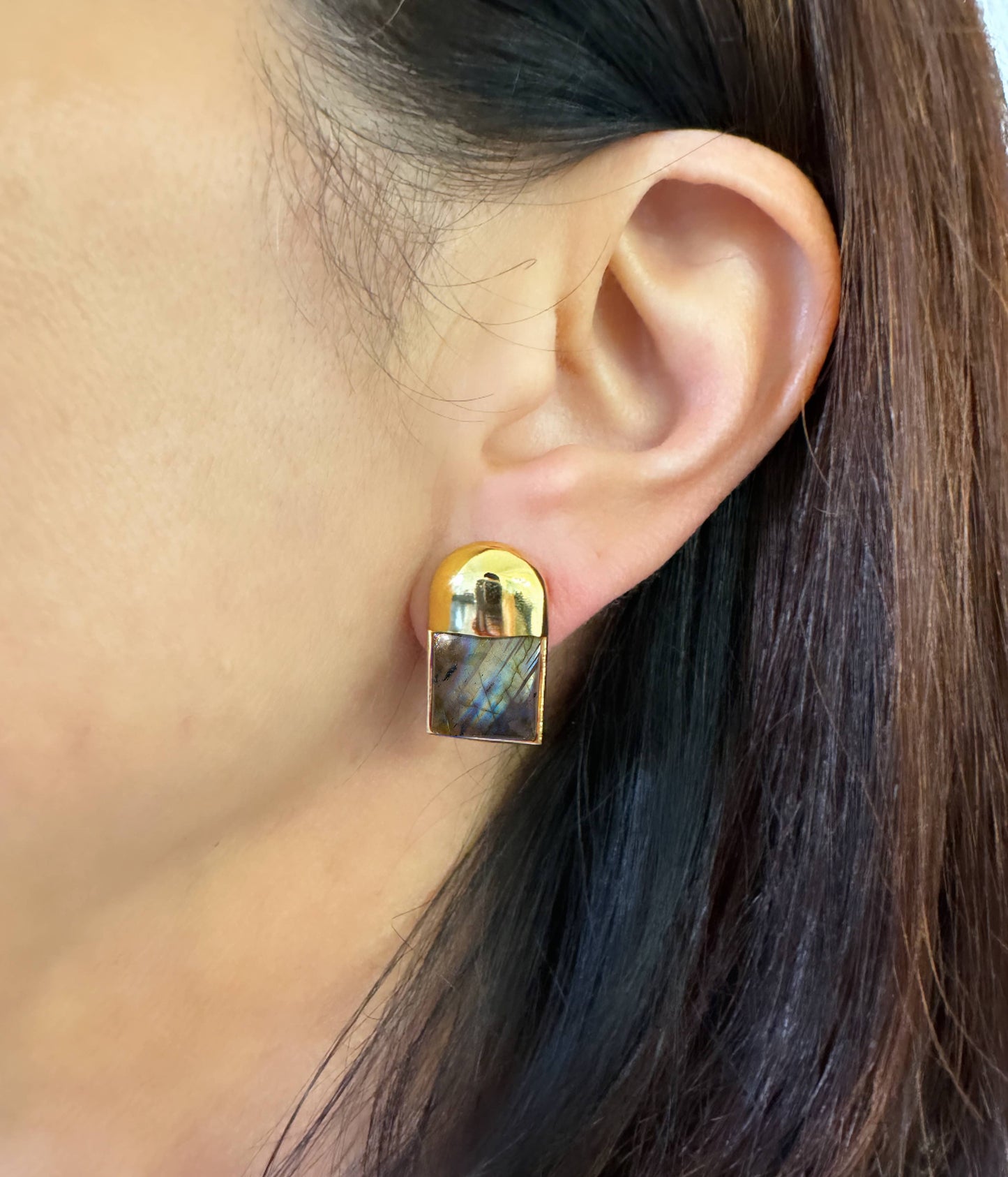 Petite modernism The Details Sculpted, sleek post earring with deco flair ¾” length 10 mm square cabochon detail Polished 14 karat gold over brass Surgical steel post with large hypoallergenic silicone back