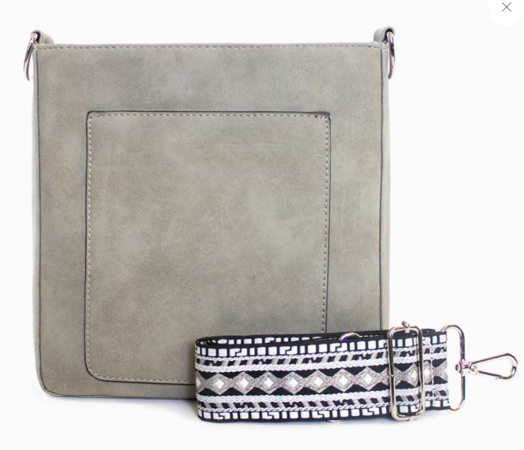 The May Suede Crossbody Bag in grey is sure to become your new favorite with its soft, rich material, vibrant colors, and unique guitar straps. Plus, it comes with a matching long strap for more conservative days. In the spirit of K. Carroll, with our anniversary month being May, we've added good vibes to this bag. Specific details include a top snap closure, open front pocket, inside zipper wall pocket, four RFID protected built-in card slots, and silver hardware. Made with vegan leather, this bag measures