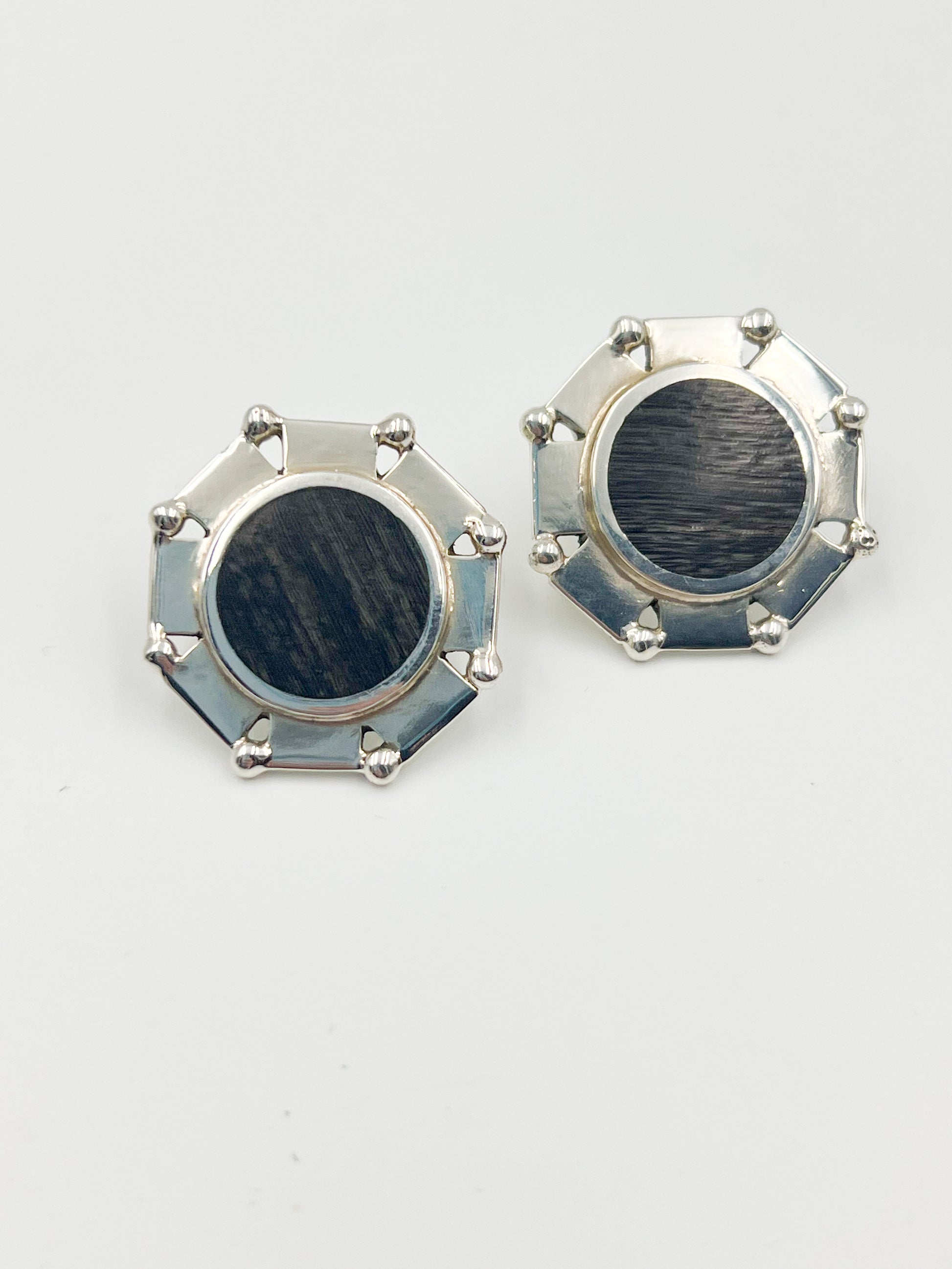 Check out these eccentric Spralting Silver and Ebony Disc Earrings with a post backing. The ebony used is a unique black/brown hardwood that adds an unexpected touch. Every item created since 1979 under the Sucesores de William Spratling is labeled with the Mexican registry mark TS-24 and an older Spratling hallmark reproduction. Keep in mind, each piece is handmade and may vary in size from the pictured one.