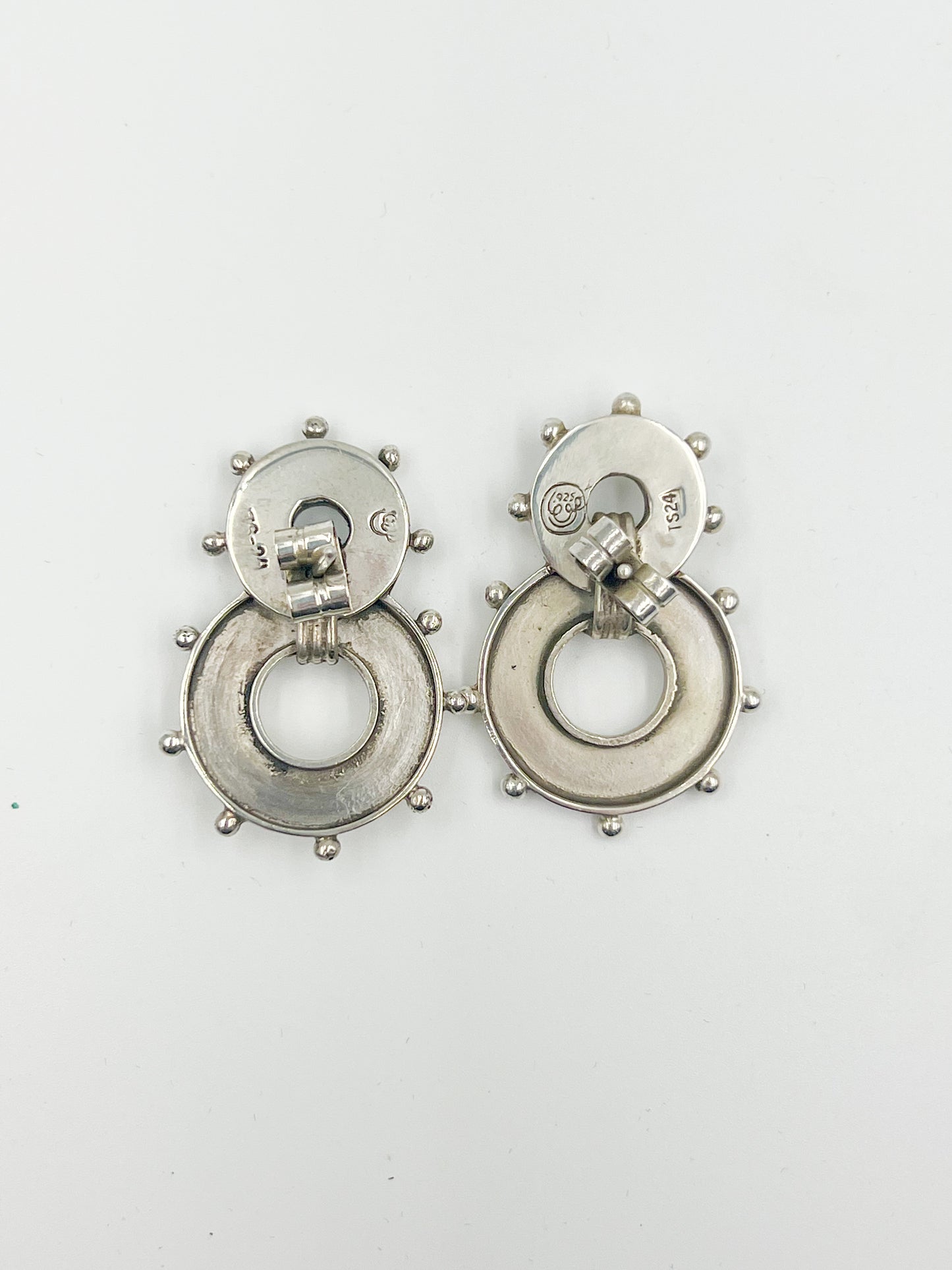 Score a funky pair of Spratling Silver Banjo Earrings, boasting a post style. All items produced since 1979 under the influence of the Sucesores de William Spratling sport the current Mexican registry mark TS-24 and a replica of the old Spratling hallmark. Keep in mind, these handmade pieces may vary in size from the photo.