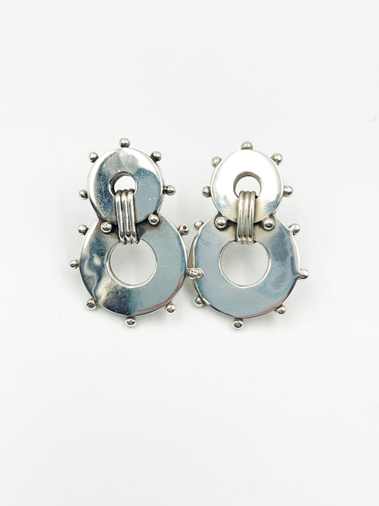 Score a funky pair of Spratling Silver Banjo Earrings, boasting a post style. All items produced since 1979 under the influence of the Sucesores de William Spratling sport the current Mexican registry mark TS-24 and a replica of the old Spratling hallmark. Keep in mind, these handmade pieces may vary in size from the photo.