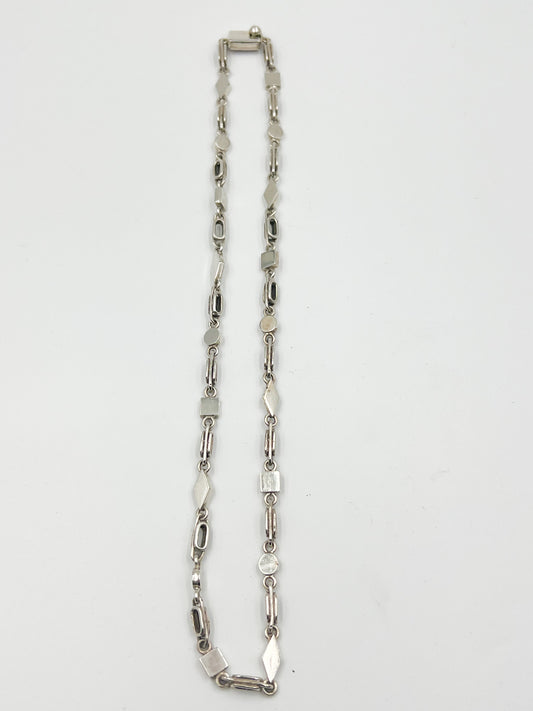 A handmade masterpiece! Featuring a playful clasp closure, this 16-18 (neck side depending) inch Spratling Silver Geometric Chain Necklace is a must-have. Complete with the iconic TS-24 Mexican registry mark and a replica of an older Spratling hallmark, every piece is unique and full of charm. Please note: sizes may vary slightly from the photo.