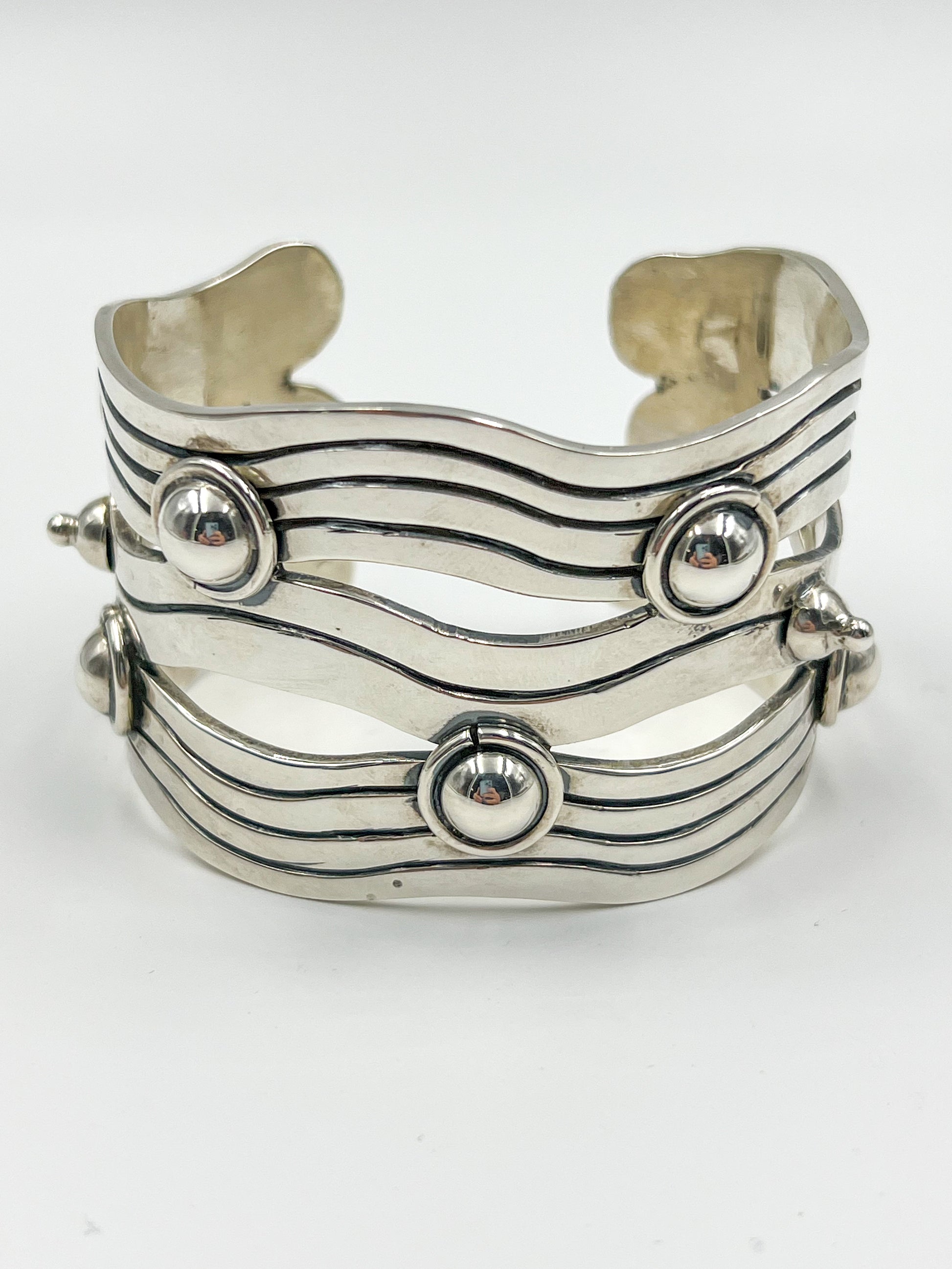 Behold the Spratling Silver River of Life Cuff! Made for small to medium sized wrists, it proudly displays the Mexican registry mark TS-24 and a replica of an older Spratling hallmark, a nod to the legacy of Sucesores de William Spratling since 1979.