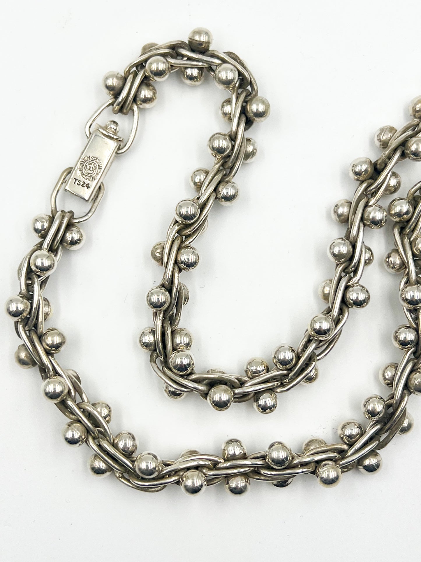 Behold the Spratling Silver Triple Link Necklace - a sterling silver delight, measuring 16 inches around and secured with a clasp closure. All items produced since 1979 by the Sucesores de William Spratling sport the Mexican registry mark TS-24 and a replica of the iconic Spratling hallmark. But here's the kicker - each piece is handmade and may vary slightly in size from the photo.