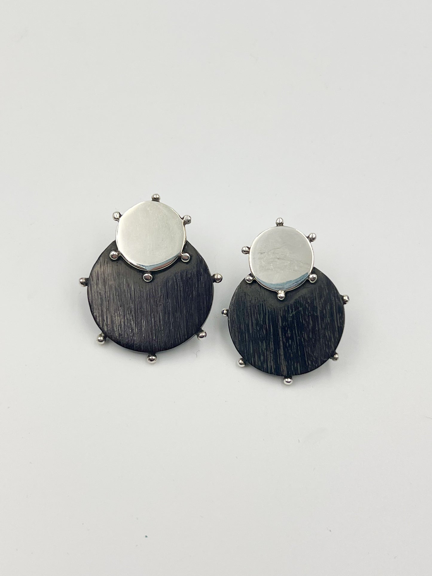 Spratling Silver and Ebony Circle Earrings. Made of ebony hardwood in black and brown tones. Features a post back for secure wearing. All items made under Sucesores de William Spratling since 1979 are stamped with Mexican registry mark TS-24 and a replica of an older Spratling hallmark. Keep in mind that each piece is handmade and may vary in size from the photo.