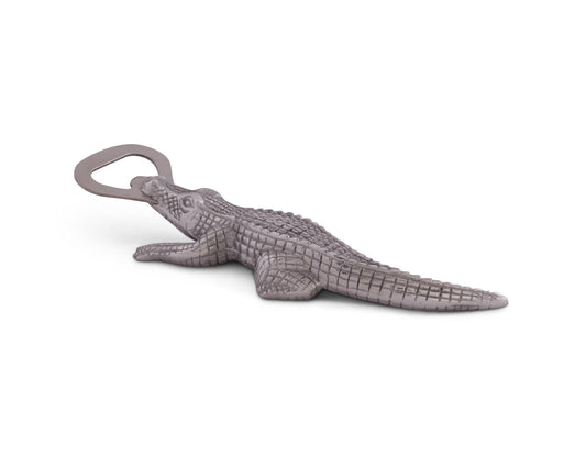 Rip the cap off any beer with this best-selling Alligator Bottle Opener from Arthur Court. Wonderfully detailed in Arthur Court's signature aluminum, this scaly alligator bites down, holding the stainless steel bottle opener with its powerful jaws. The remarkable definition in the creature's hide gives this statuette like opener a rough, naturally appealing texture. Size: L: 7.0" / W: 2.0" Care: Dust with damp cloth. Will not tarnish.